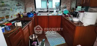 Charming kitchen with wooden cabinets and modern appliances, perfect for culinary enthusiasts.