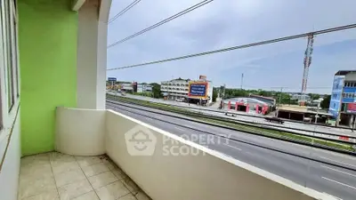 Spacious balcony with highway view in modern apartment building