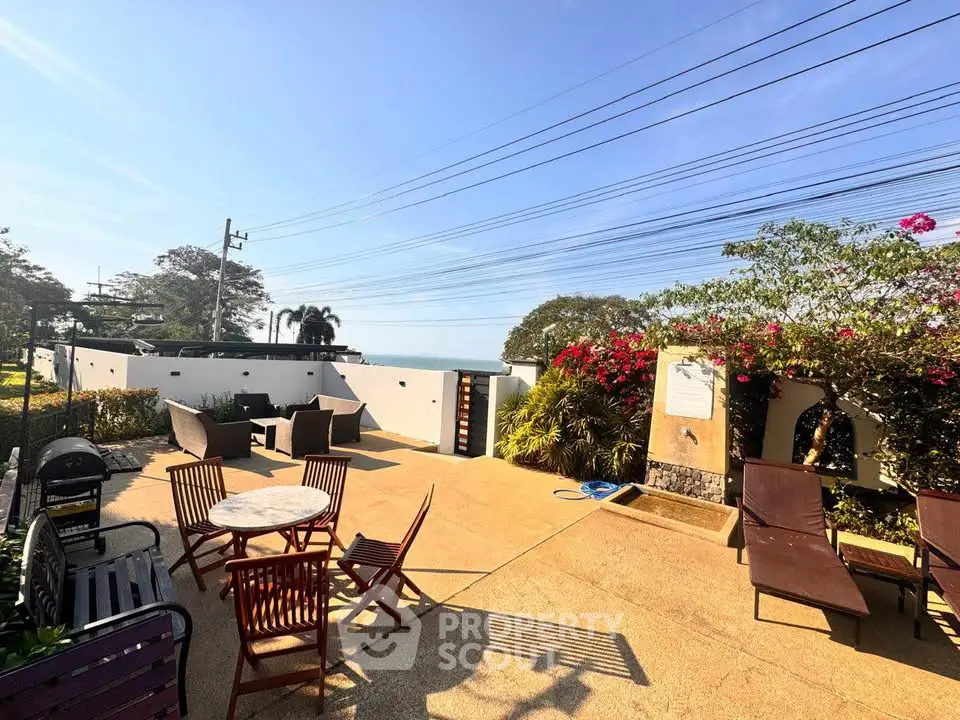 Stunning outdoor patio with seating and lush greenery, perfect for relaxation and entertaining.