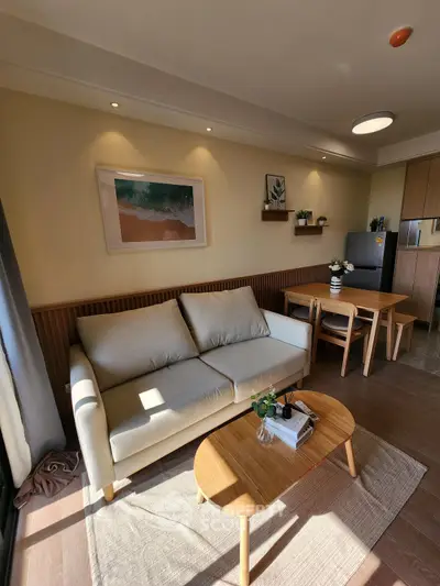 Charming living room with cozy sofa, modern decor, and natural light, perfect for relaxation.