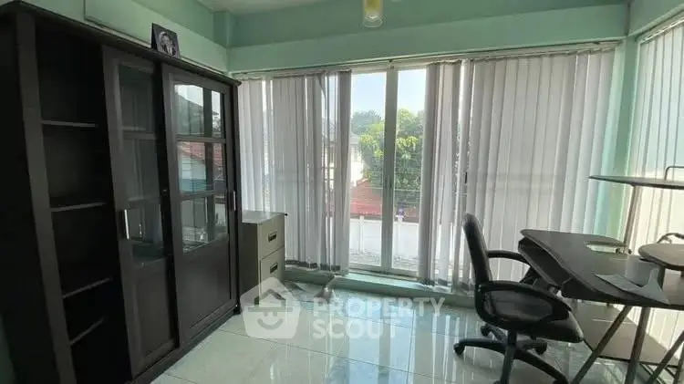 Bright study room with large windows and modern furniture