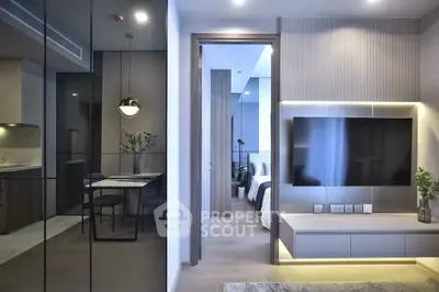 Modern open-plan living room with sleek design and integrated TV unit