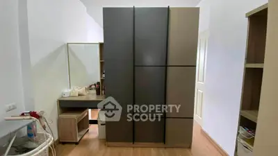 Modern bedroom with sleek wardrobe and vanity in stylish apartment