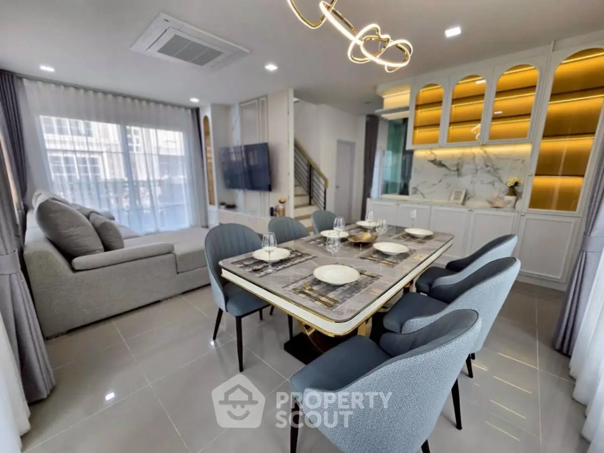 Modern open-plan living and dining area with stylish decor and ample natural light.