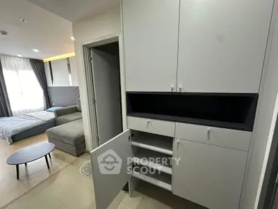 Modern apartment interior with sleek storage and cozy living area