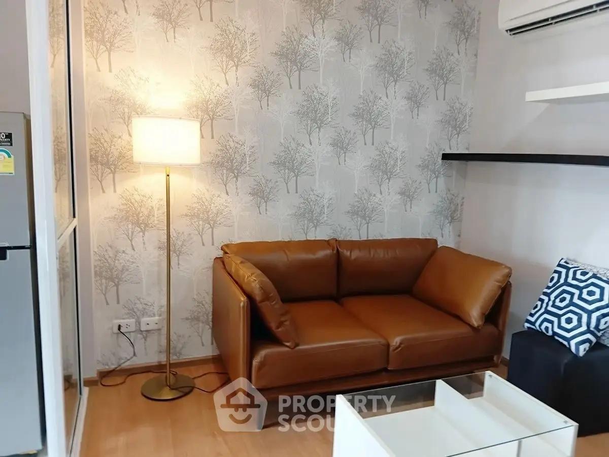 Cozy living room with leather sofa and stylish wallpaper