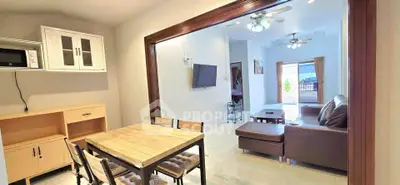 Spacious open-plan living and dining area with modern furnishings and natural light.