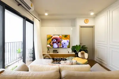 Modern living room with cozy sofa, wall-mounted TV, and balcony view