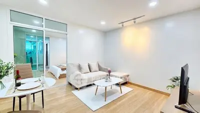 Modern living room with cozy sofa and elegant decor in open layout apartment.