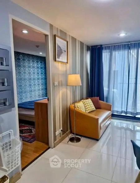 Modern living room with cozy seating and stylish decor in a well-lit apartment.