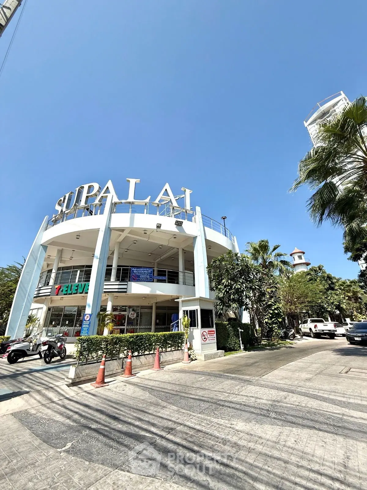 Modern commercial building with retail space and lush landscaping