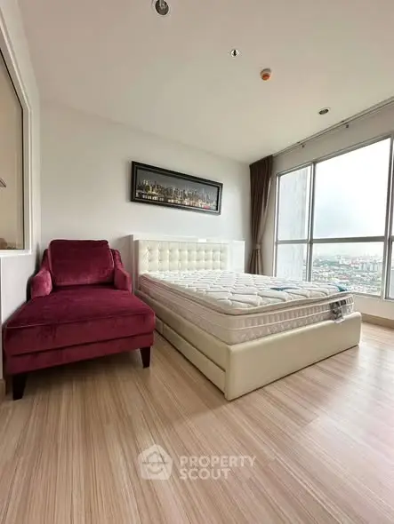 Spacious bedroom with large window and elegant decor