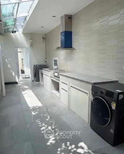 Spacious modern kitchen with sleek appliances and ample natural light