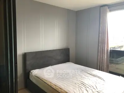 Modern bedroom with large window and minimalist design, featuring a comfortable bed and neutral tones.