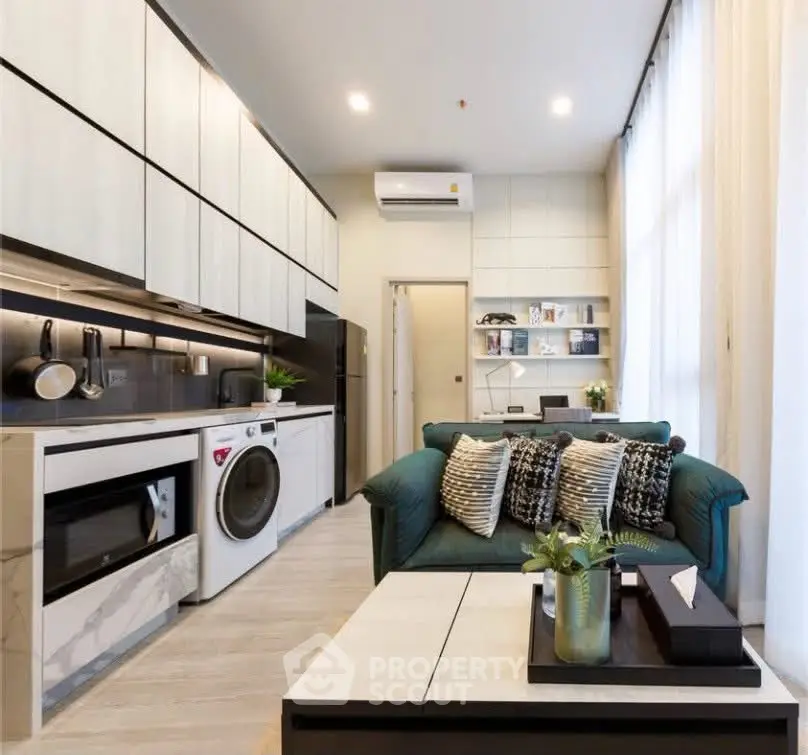 Modern living room with sleek kitchen, stylish decor, and natural light, perfect for urban living.