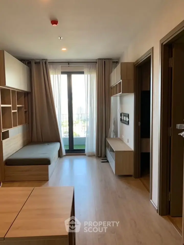 Modern apartment interior with wooden furniture and large window view