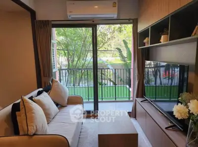 Cozy living room with modern decor and balcony view, perfect for relaxation and entertainment.