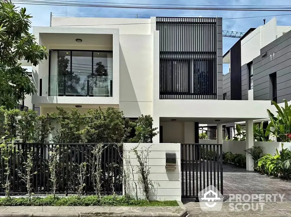 Modern architectural home with sleek design and lush greenery, perfect for luxury living.