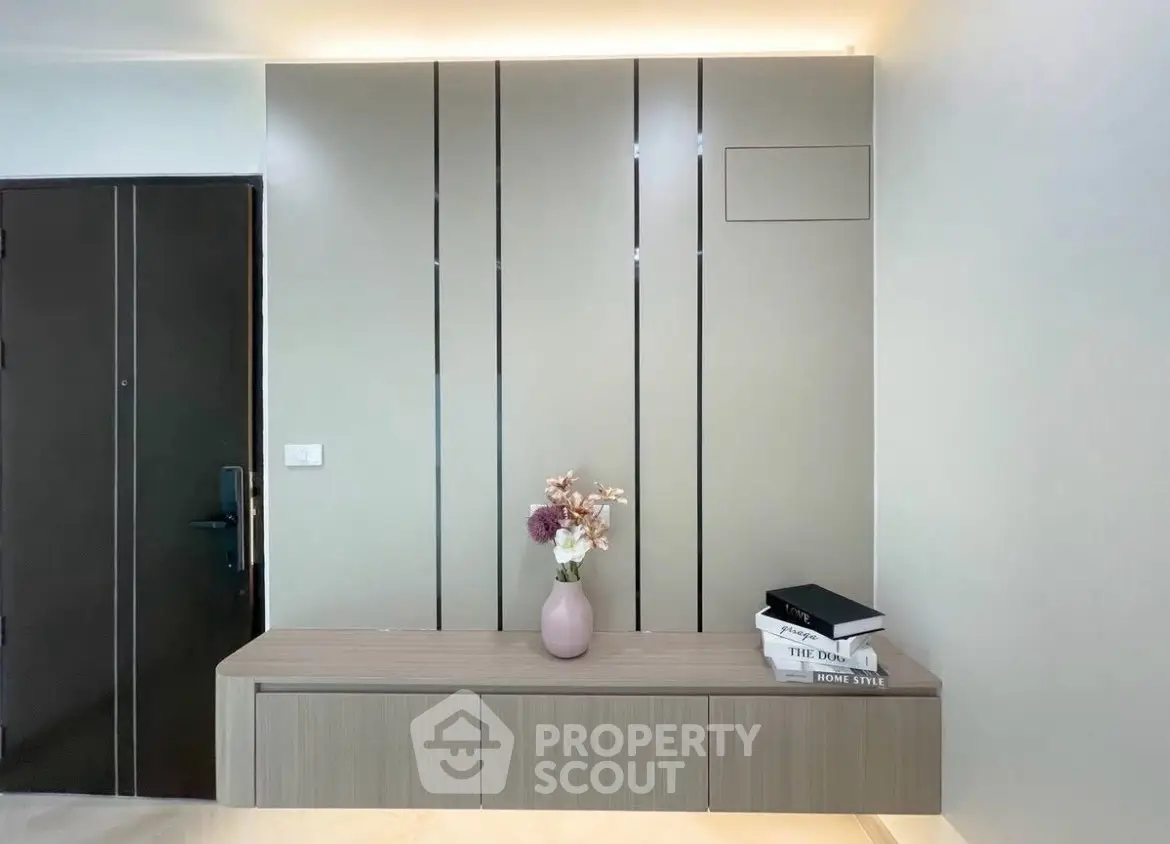 Modern interior with sleek wall paneling and stylish console table with decor.