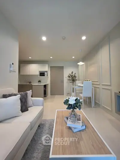 Modern living room with cozy sofa and stylish dining area in open layout apartment.