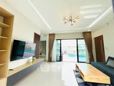 Spacious modern living room with pool view and elegant decor