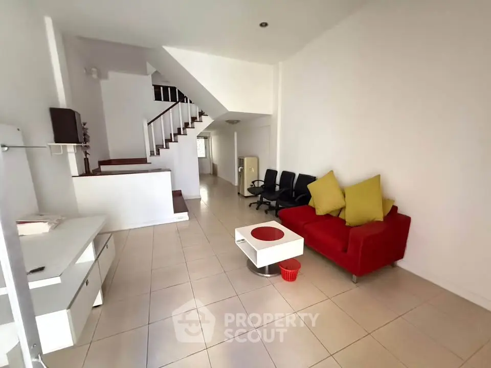 Spacious living room with modern decor and staircase in a bright home