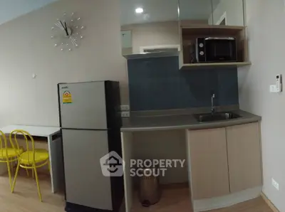 Modern compact kitchen with stainless steel appliances and stylish decor