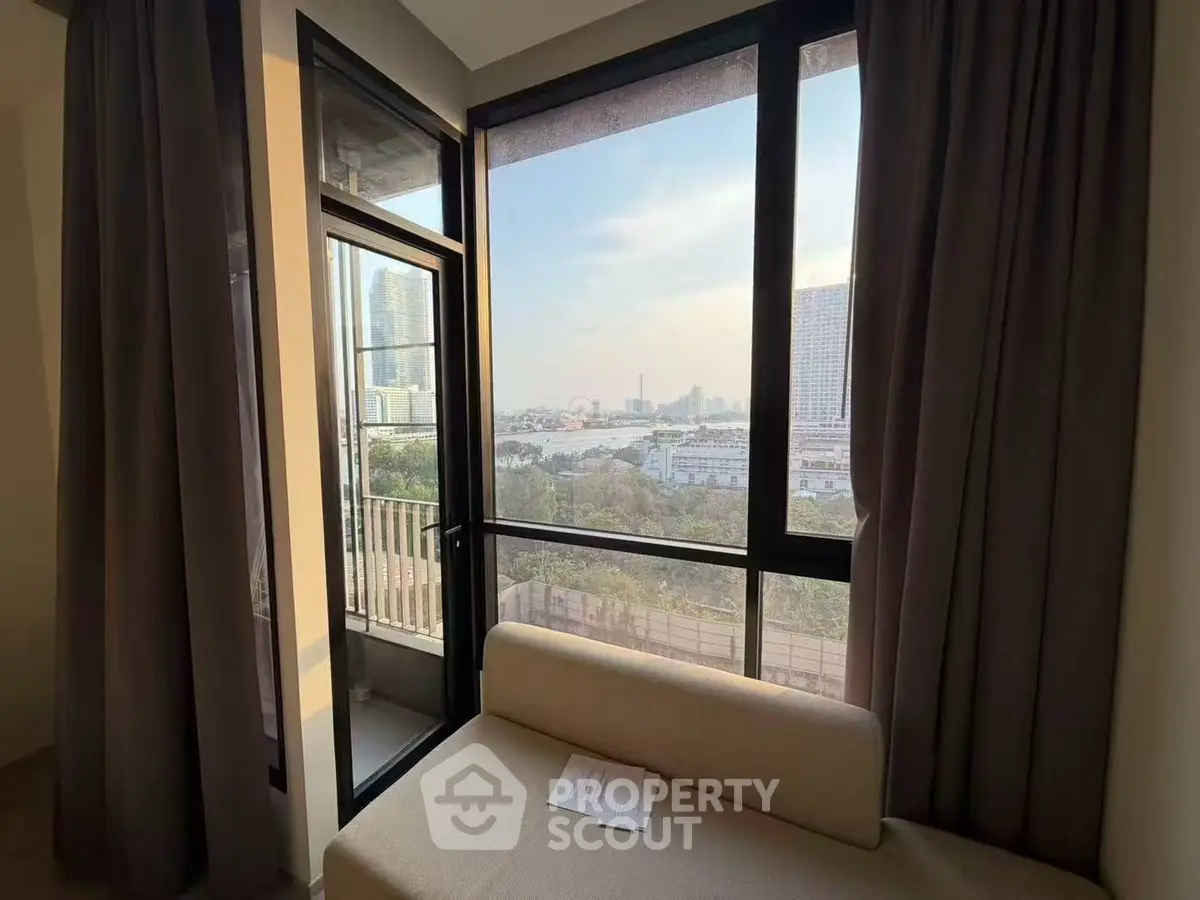 Spacious apartment with large windows offering stunning city views and abundant natural light.