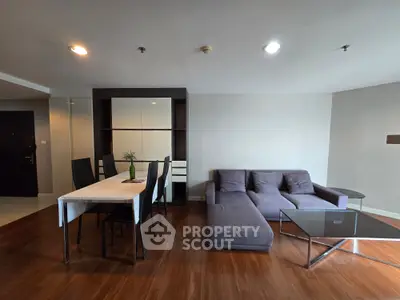 Spacious modern living room with stylish furniture and dining area, perfect for entertaining guests.