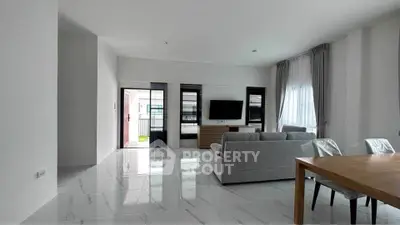 Spacious modern living room with sleek furniture and large windows