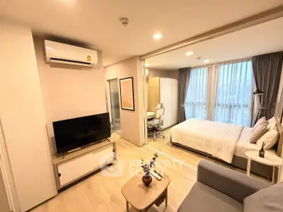Modern studio apartment with open layout, featuring cozy living area and stylish bedroom.