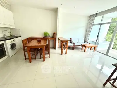 Spacious living room with modern kitchen and natural light