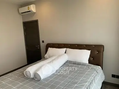 Modern bedroom with stylish bed and air conditioning unit, perfect for comfort and relaxation.