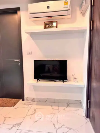 Modern interior with sleek air conditioning and minimalist TV setup on marble flooring.