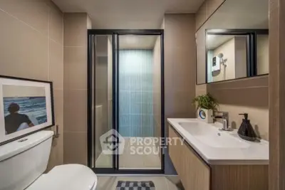 Modern bathroom with sleek shower and stylish vanity in contemporary apartment