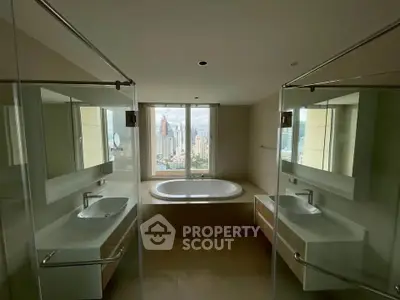 Luxurious bathroom with dual sinks and a stunning city view from the bathtub.