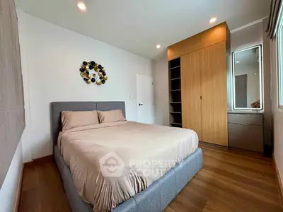 Modern bedroom with stylish decor and ample storage space