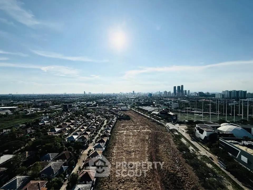 Stunning aerial view of urban landscape with clear skies and city skyline in the distance.
