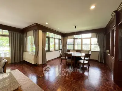 Spacious living room with elegant wooden flooring and large windows