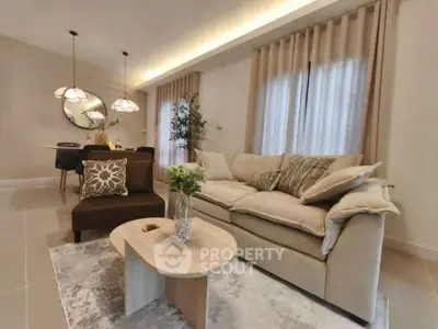 Elegant living room with cozy sofa, stylish decor, and modern lighting in a contemporary apartment.