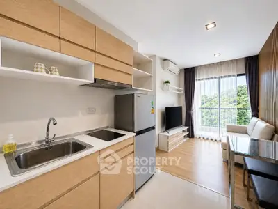 Modern open-layout kitchen and living room with natural light and scenic view.