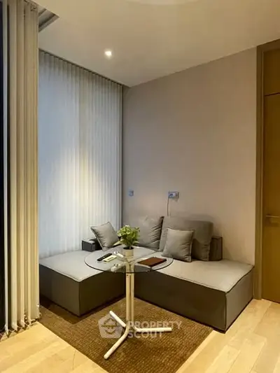 Modern cozy corner with stylish seating and glass table in a contemporary apartment.