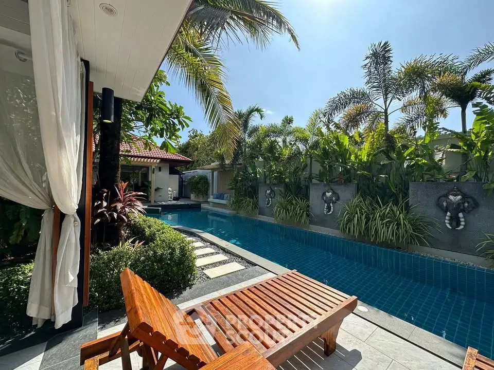 Luxurious tropical villa with private pool and lush garden, perfect for relaxation and leisure.