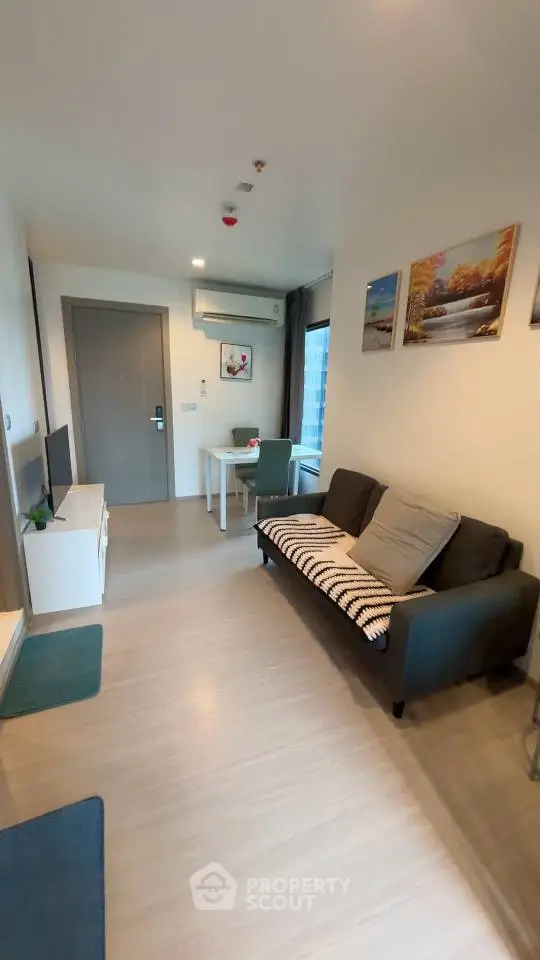 Modern living room with cozy sofa and dining area in stylish apartment