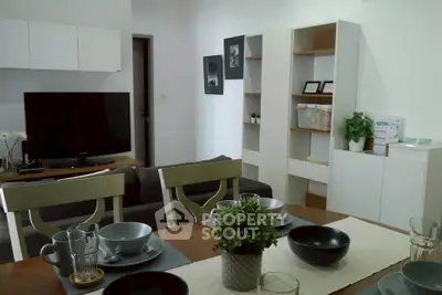 Modern living room with dining area, stylish decor, and natural light.