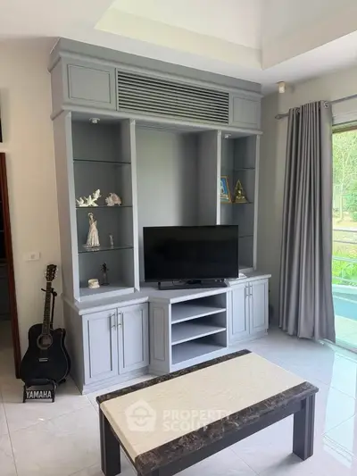 Modern living room with stylish entertainment center and natural light