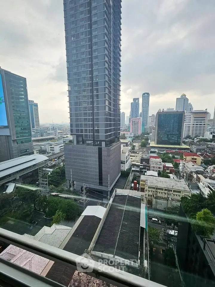 Stunning cityscape view from high-rise building balcony in urban area.
