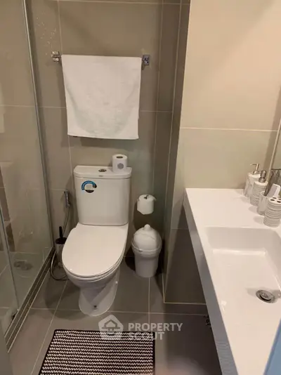 Modern bathroom with sleek fixtures and glass shower enclosure