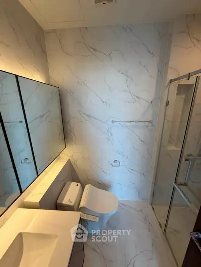 Luxurious modern bathroom with marble tiles and sleek fixtures