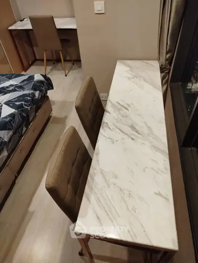 Modern bedroom with elegant marble desk and comfortable seating